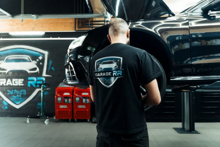 Technicien du Garage RR au travail sous capot à Ecublens